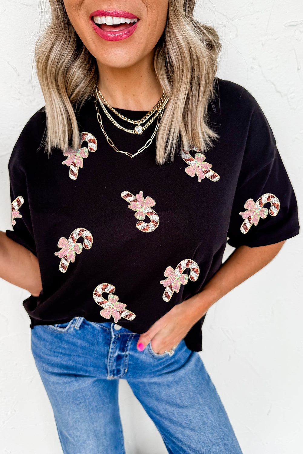 Black sequined candy cane holiday patch pattern on black t-shirt